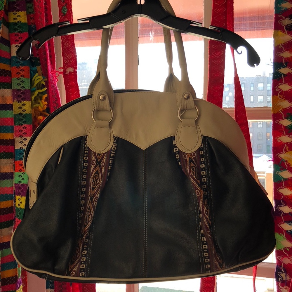 Cowhide and hand woven wool on the sides.